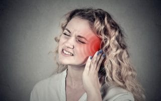 Woman suffering from tinnitus